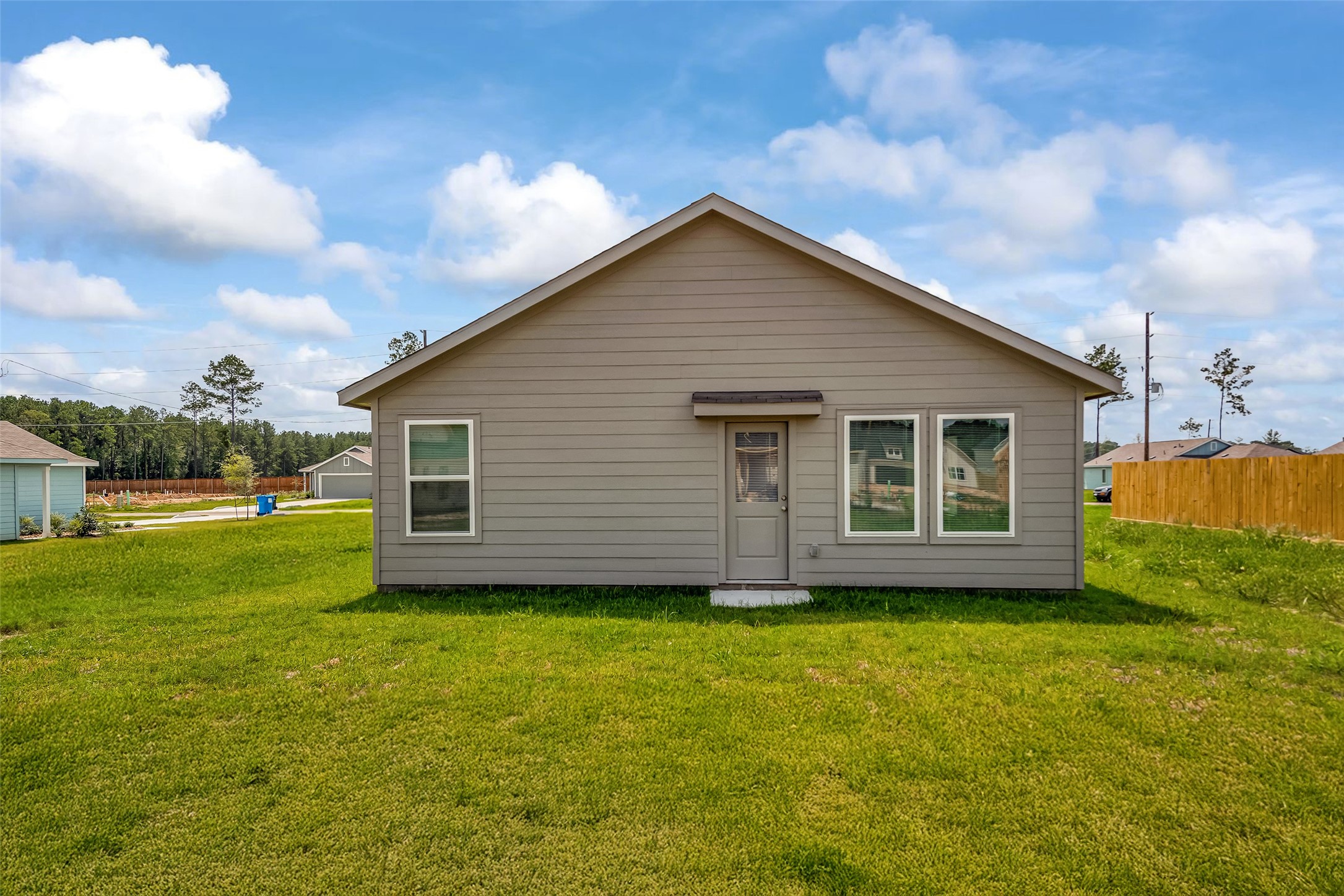 18739 Barrichello Drive Conroe, TX 77306 - Photo 14 of 15 a view of a house with yard and a garden