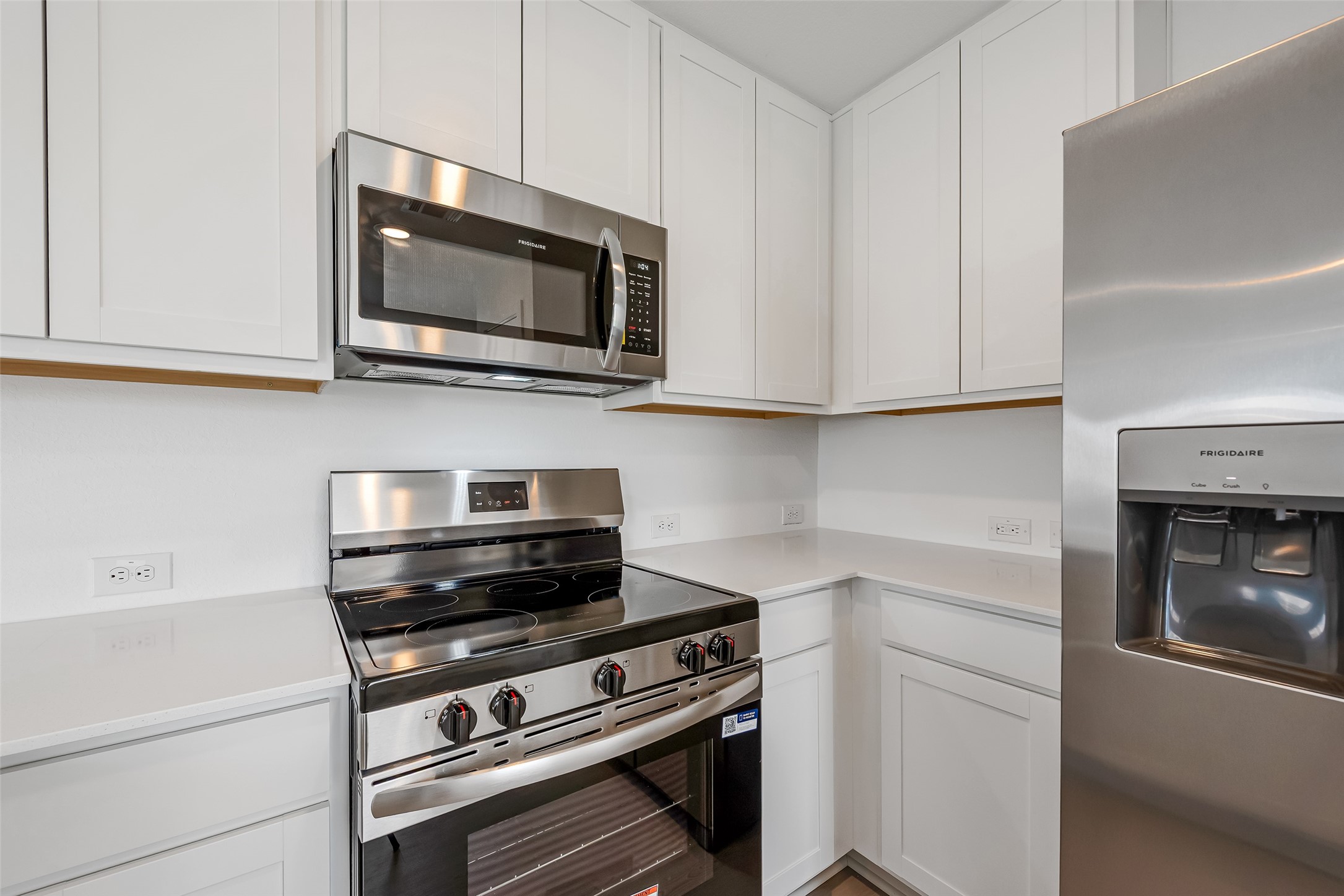 18739 Barrichello Drive Conroe, TX 77306 - Photo 5 of 15 a kitchen with stainless steel appliances a stove microwave and sink