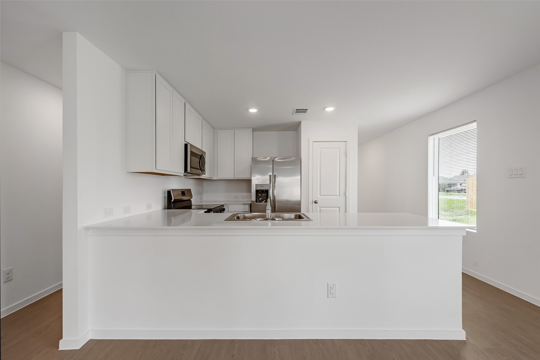 18739 Barrichello Drive Conroe, TX 77306 - Photo 7 of 15 a kitchen with stainless steel appliances granite countertop a sink a stove a refrigerator a microwave and cabinets