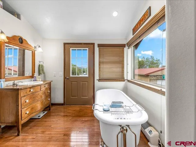 a view of a kitchen with granite countertop a sink and a refrigerator