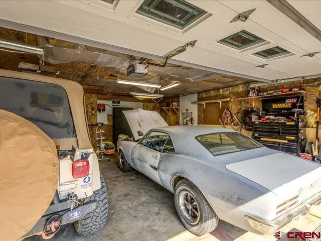 a view of a patio with table and chairs potted plants with wooden floor and fence