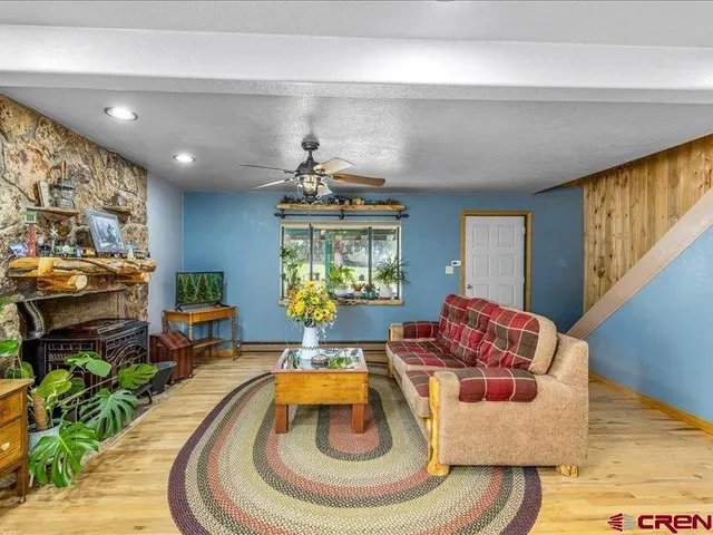 a living room with furniture and a floor to ceiling window