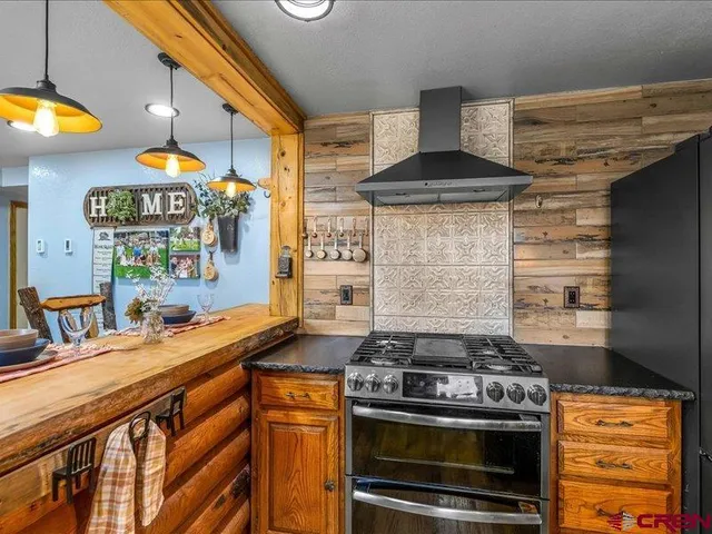 a kitchen with stainless steel appliances a stove and a sink