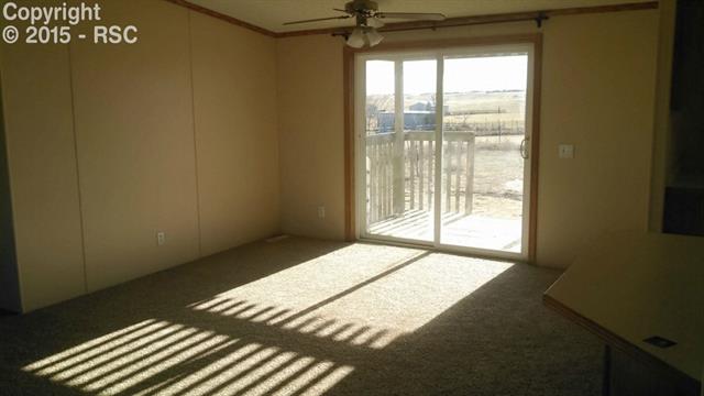 6020 Peerless Farms Road Peyton, CO 80831 - Photo 4 of 8 Separate dining area and walk out to another covered deck