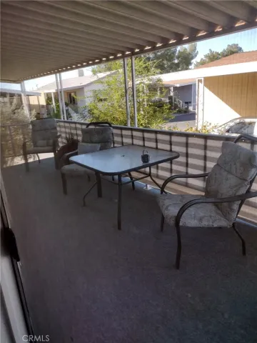 a view of a outdoor kitchen with a table and chairs