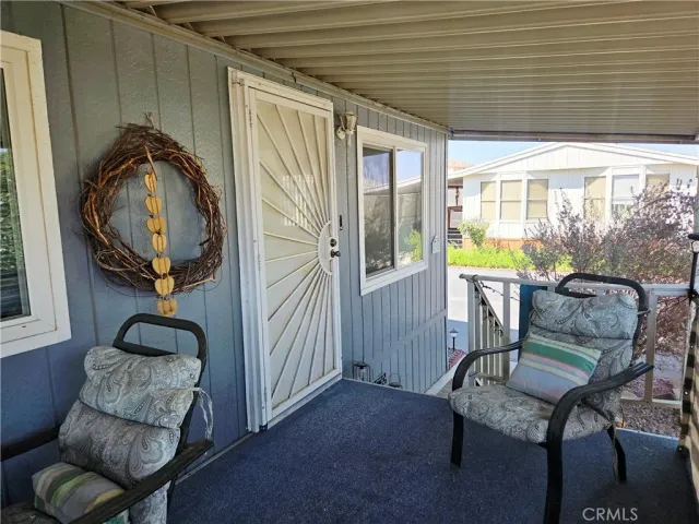 a view of a livingroom with furniture and a large window