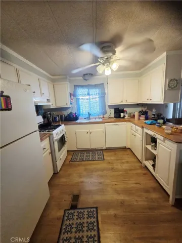 a kitchen with granite countertop a sink stainless steel appliances and cabinets