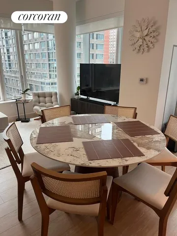 a dining room with furniture and window