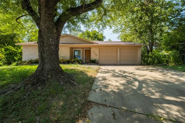 a front view of house with yard and trees