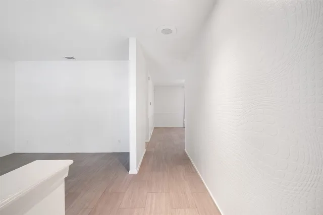 a view of a room with wooden floor
