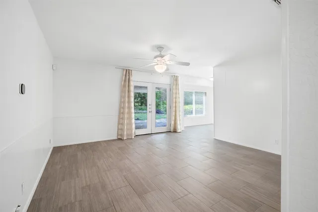 wooden floor in an empty room with a window