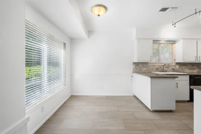 a kitchen with a sink cabinets and window