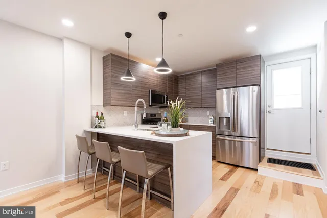 a kitchen with kitchen island a counter top space appliances and cabinets