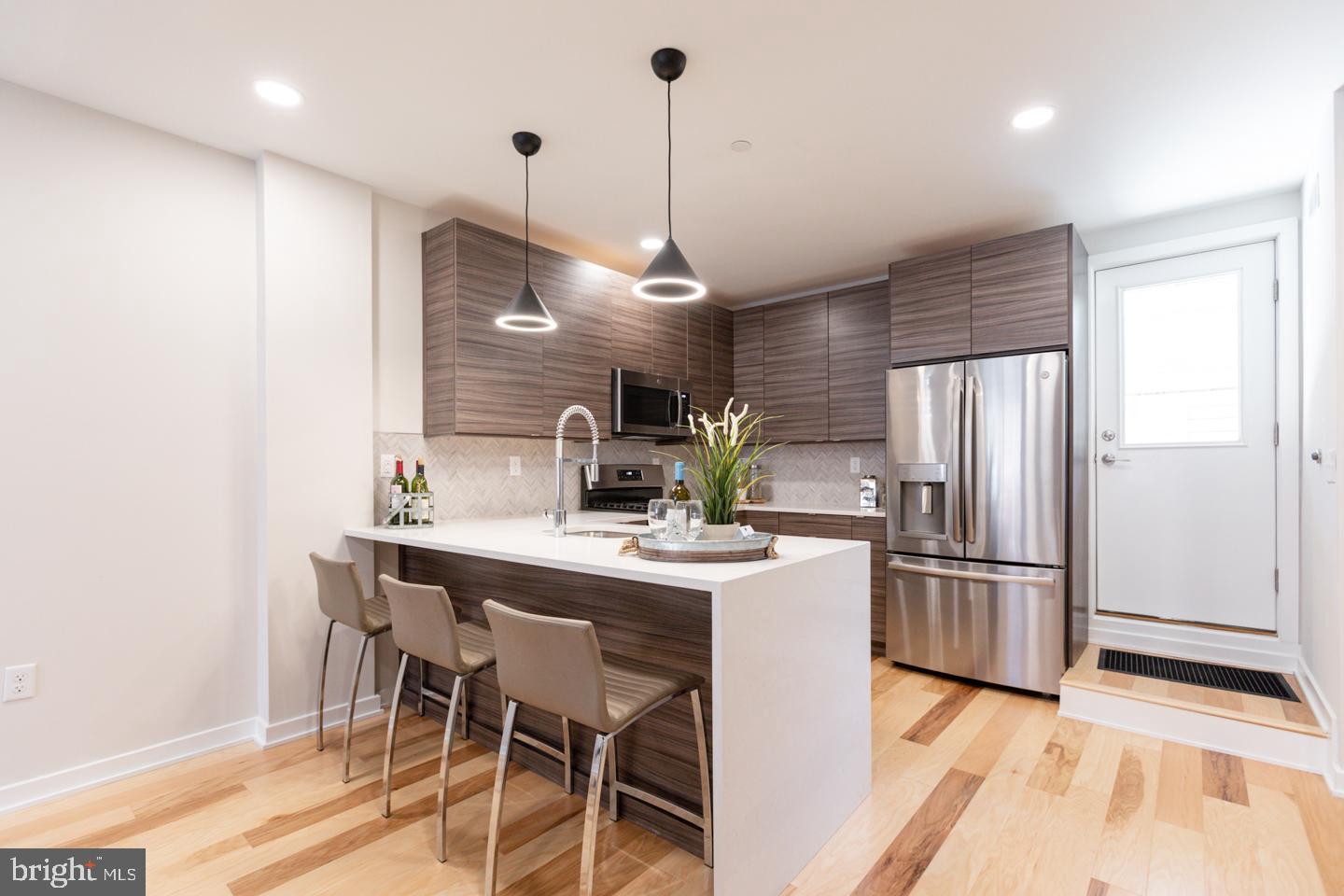 1322 Hope Street, Unit A Philadelphia, PA 19122 - Photo 11 of 30 a kitchen with kitchen island a counter top space appliances and cabinets