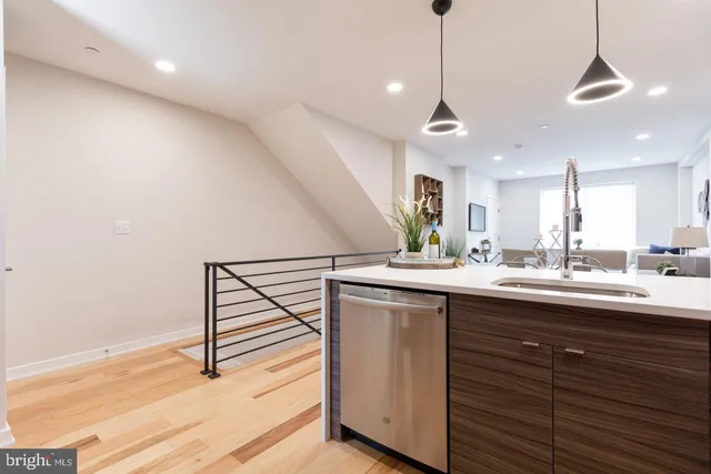 a kitchen with kitchen island a sink stainless steel appliances and cabinets