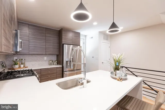 a kitchen with granite countertop a sink a counter and cabinets