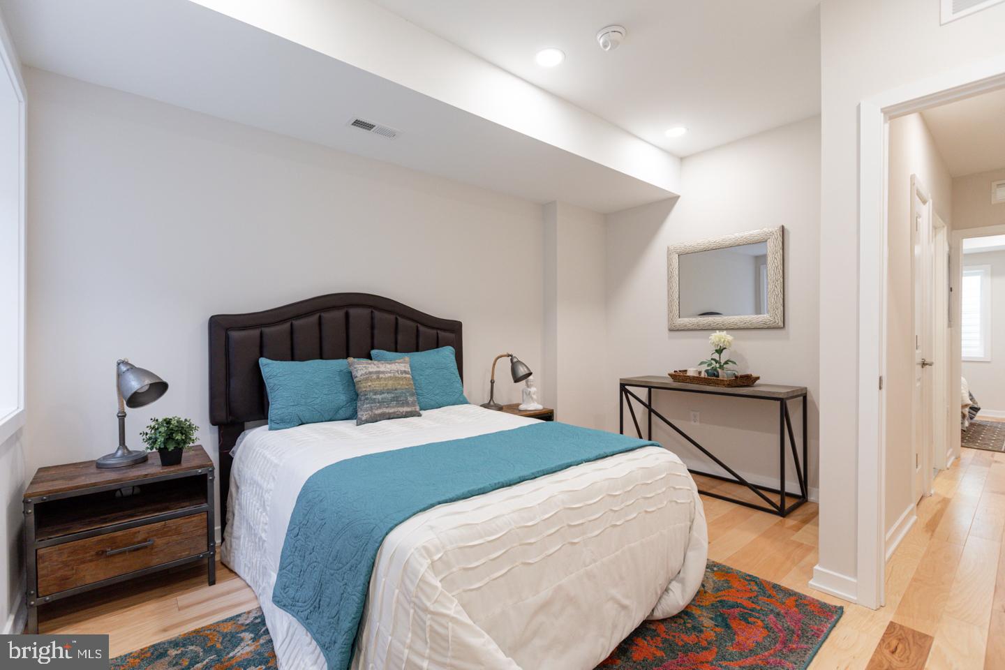 1322 Hope Street, Unit A Philadelphia, PA 19122 - Photo 20 of 30 a bedroom with a bed and wooden floor