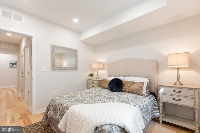 a bedroom with a bed and a night stand