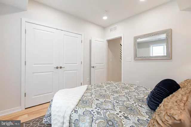 a bedroom with a bed and a closet