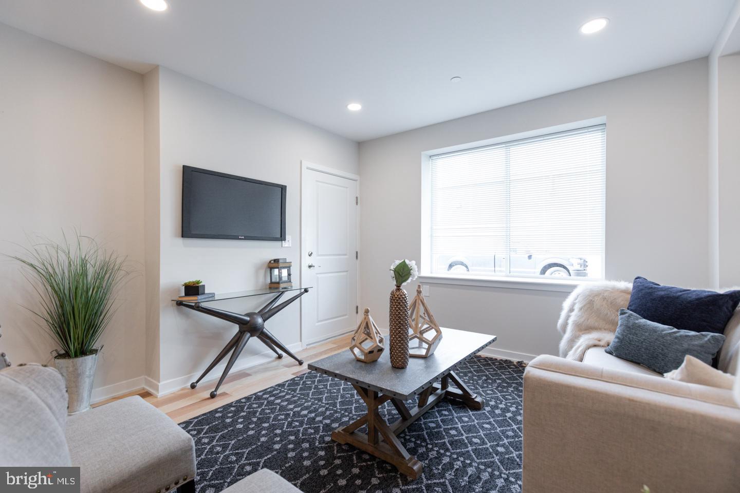 1322 Hope Street, Unit A Philadelphia, PA 19122 - Photo 5 of 30 a living room with furniture and a flat screen tv