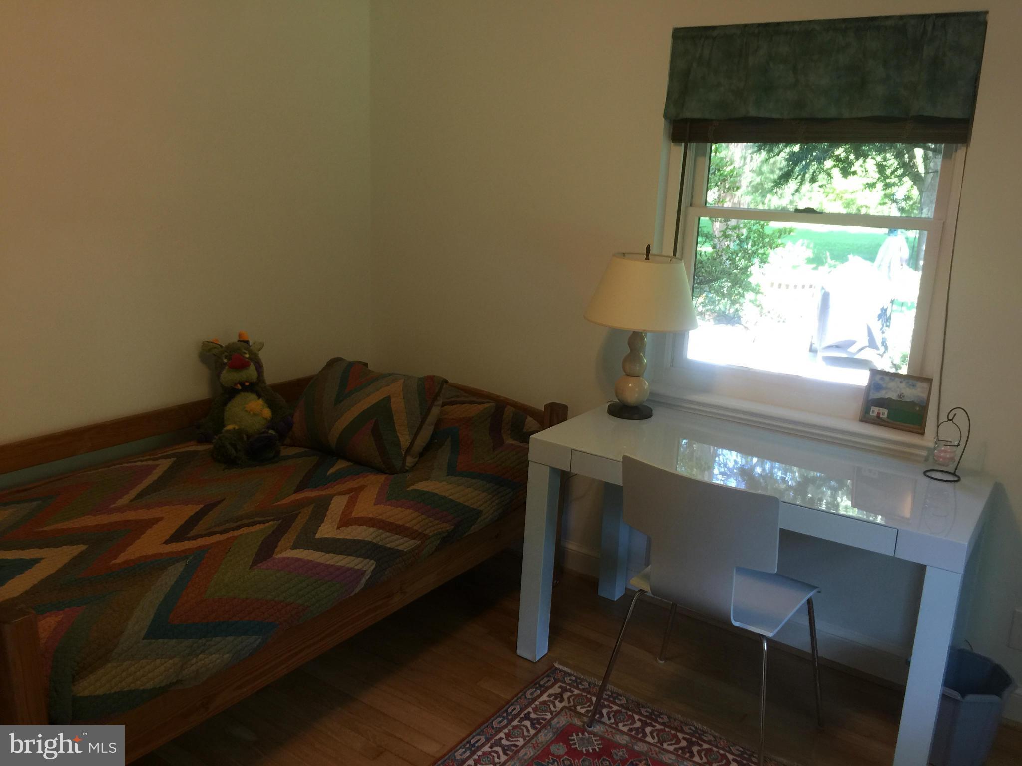 910 Notley Road Silver Spring, MD 20904 - Photo 20 of 28 a bed sitting in a bedroom next to a window