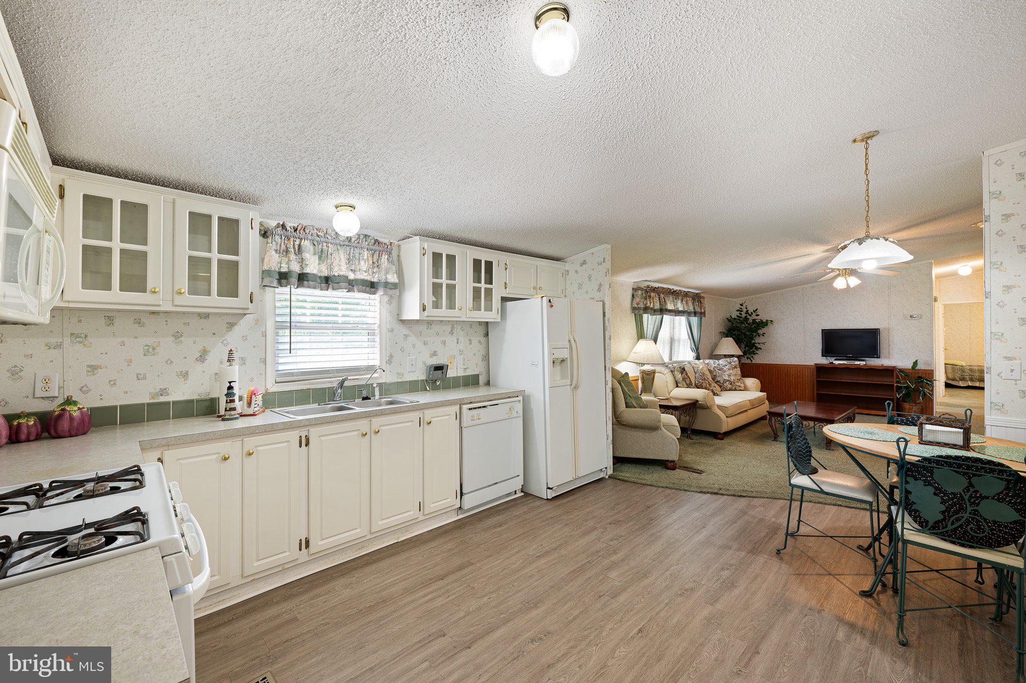 29044 Log Cabin Hill Road Lewes, DE 19958 - Photo 11 of 36 a open kitchen with sink cabinets and wooden floor