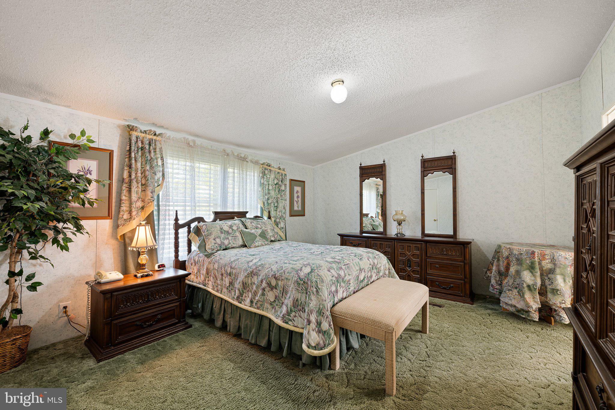29044 Log Cabin Hill Road Lewes, DE 19958 - Photo 13 of 36 a bed room with a bed and a chair