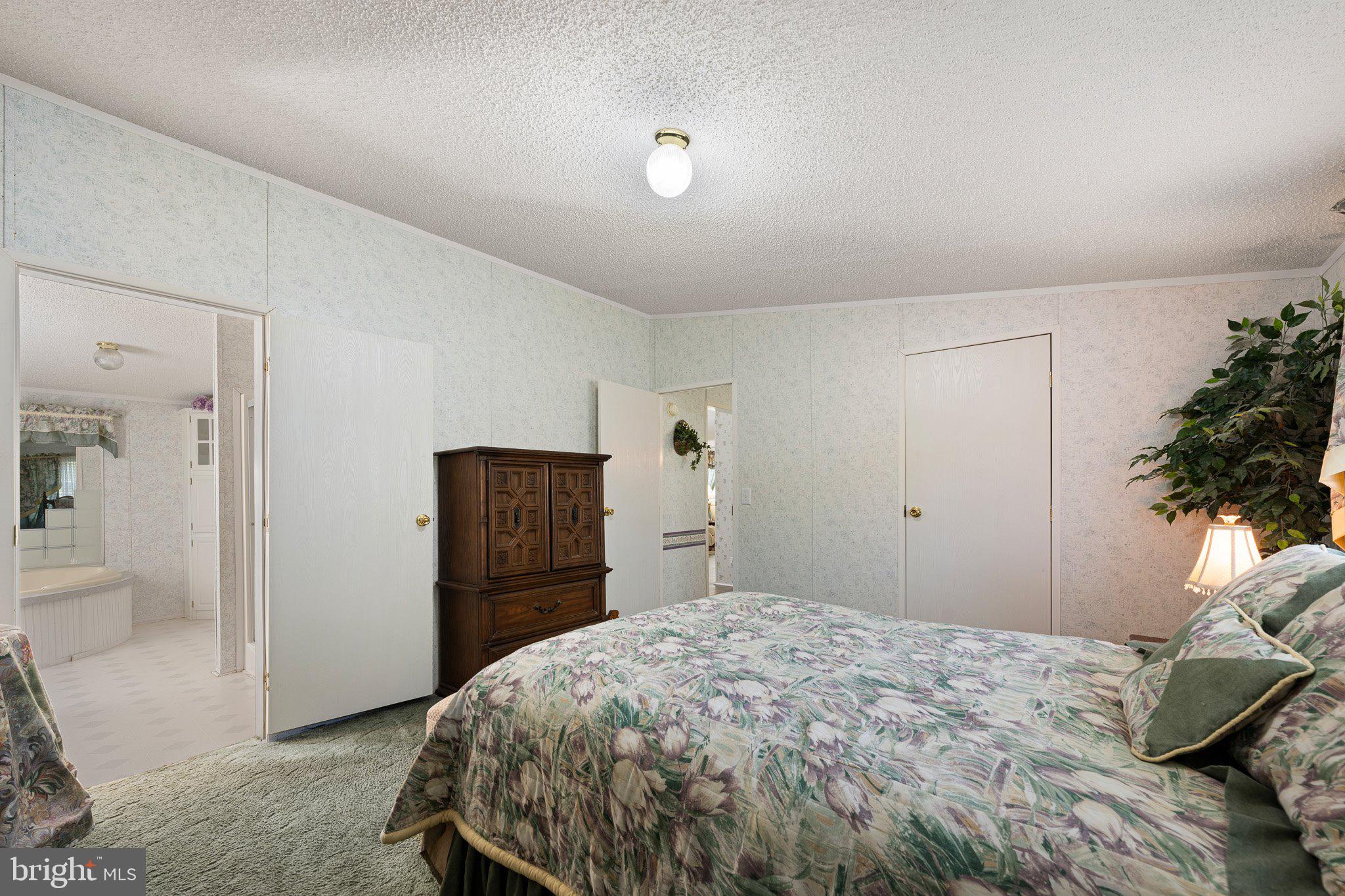 29044 Log Cabin Hill Road Lewes, DE 19958 - Photo 15 of 36 a bedroom with a bed and a dresser