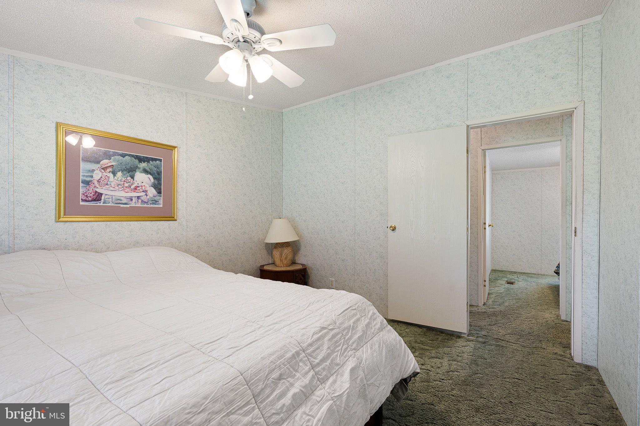 29044 Log Cabin Hill Road Lewes, DE 19958 - Photo 18 of 36 a bedroom with a bed and a painting on the wall