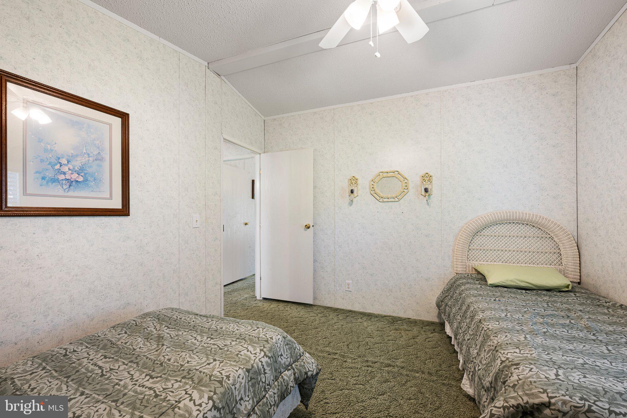 29044 Log Cabin Hill Road Lewes, DE 19958 - Photo 23 of 36 a bedroom with a bed and a painting on the wall