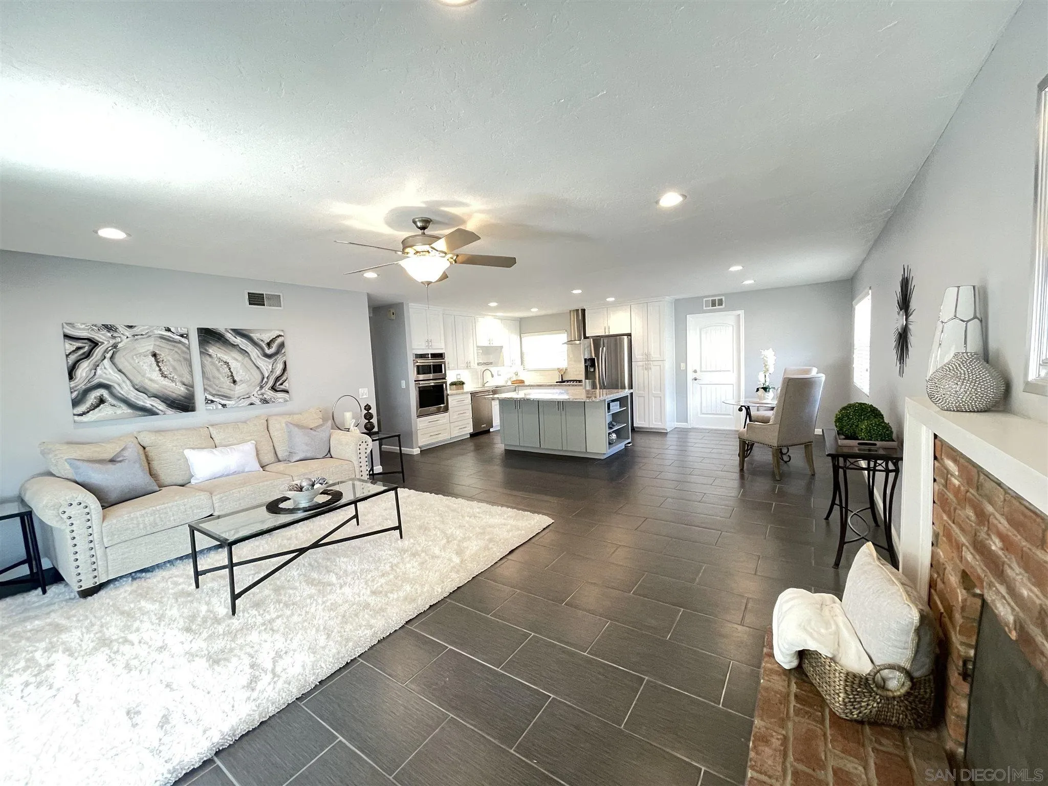 13717 Tobiasson Road Poway, CA 92064 - Photo 2 of 13 a living room with furniture and a dining table with wooden floor