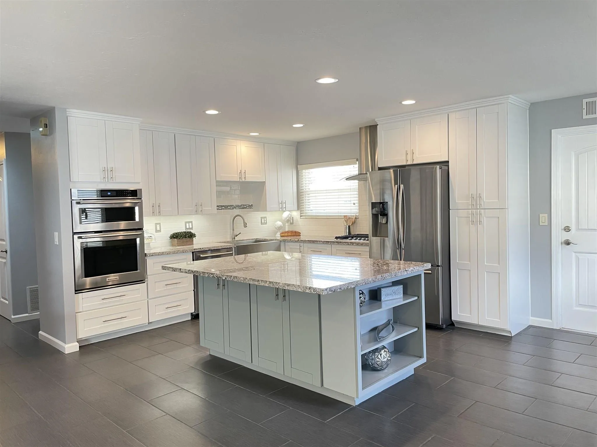 13717 Tobiasson Road Poway, CA 92064 - Photo 3 of 13 a kitchen with stainless steel appliances a stove a refrigerator and a sink