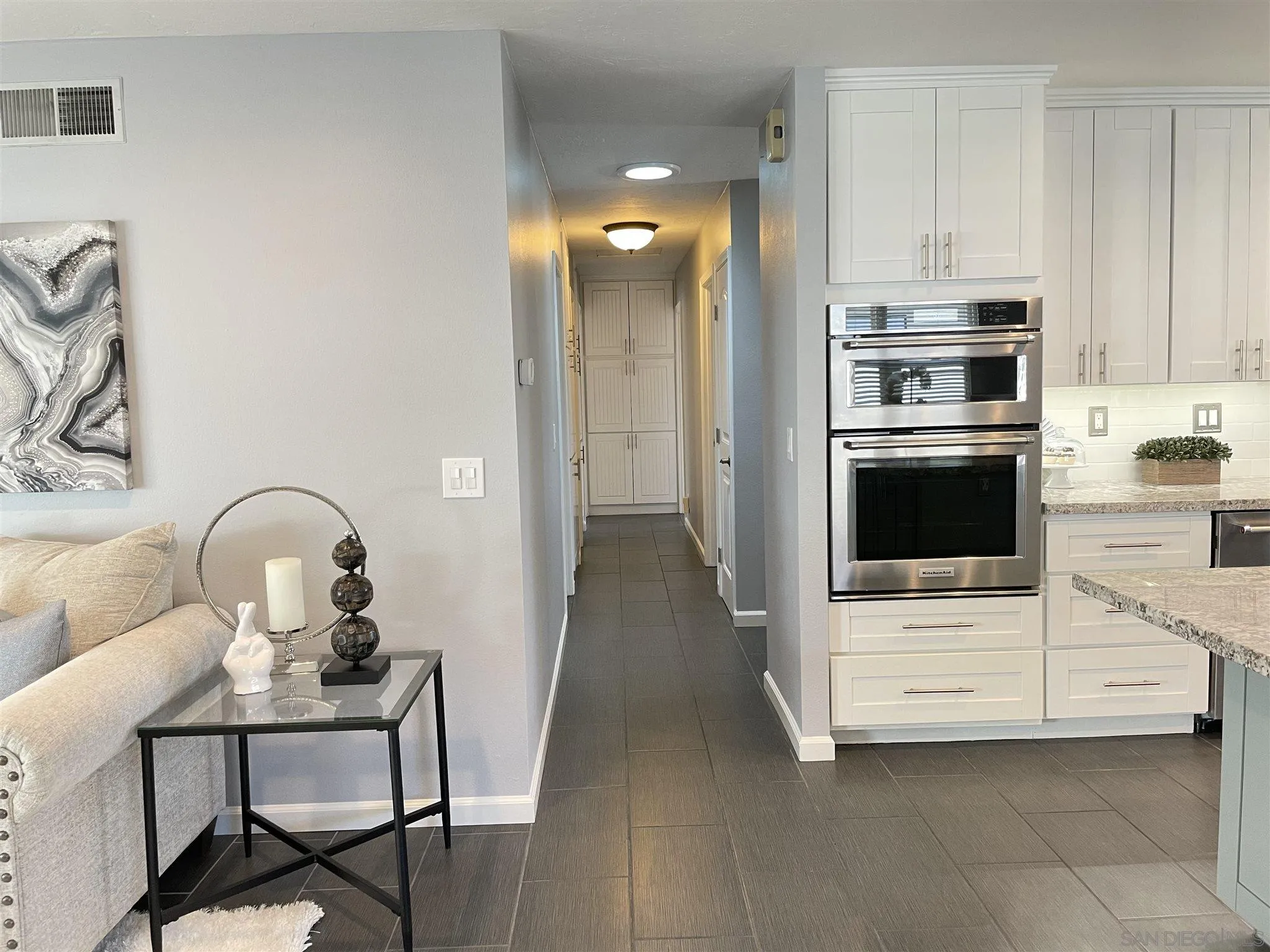 13717 Tobiasson Road Poway, CA 92064 - Photo 4 of 13 a kitchen with a refrigerator and a stove top oven