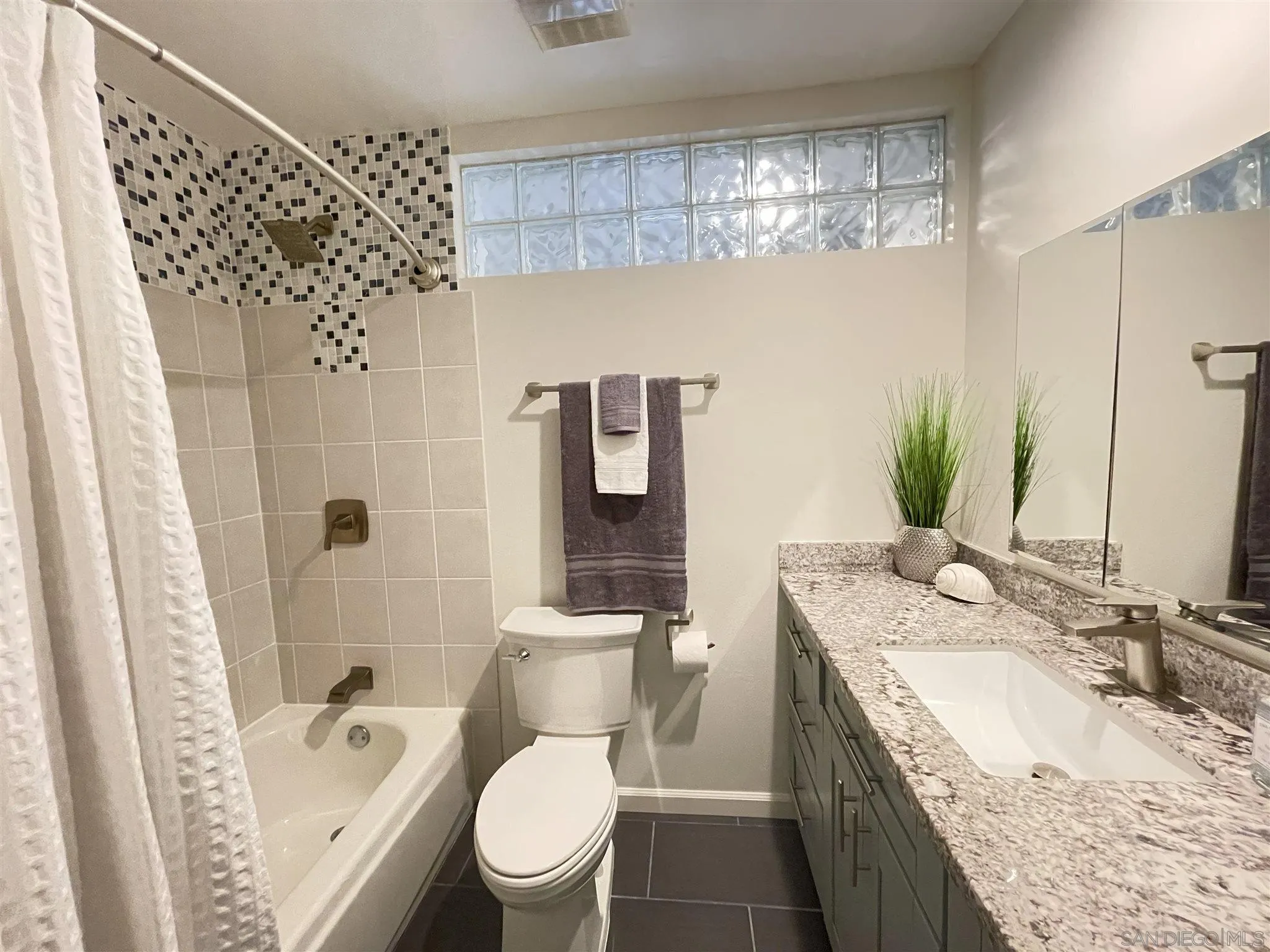 13717 Tobiasson Road Poway, CA 92064 - Photo 5 of 13 a bathroom with a granite countertop sink toilet and shower