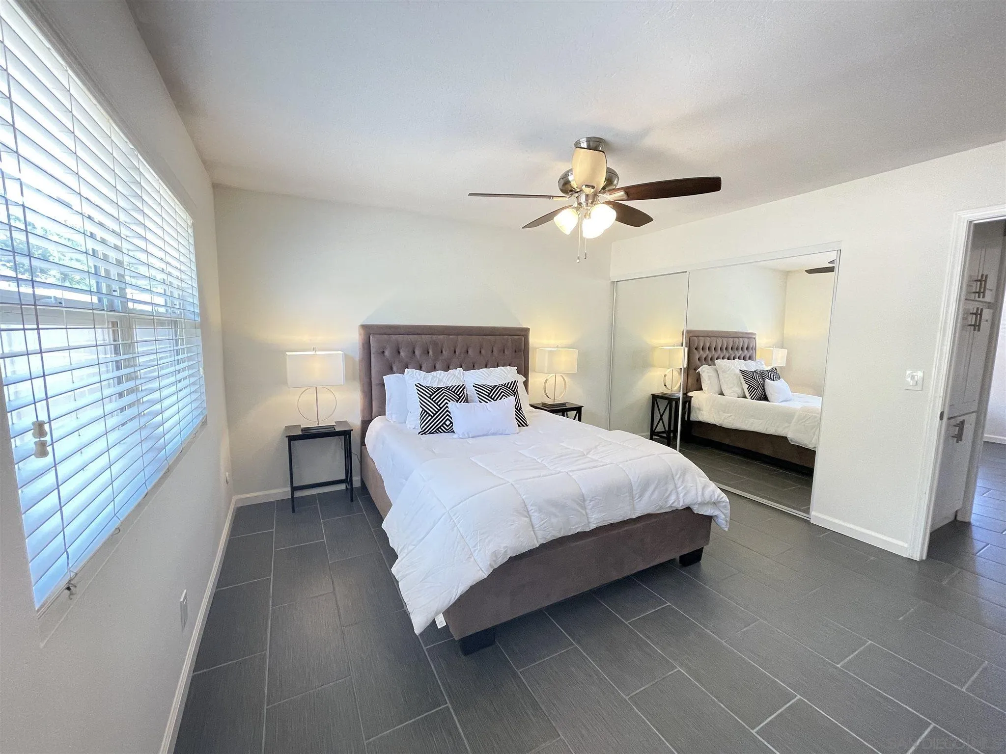 13717 Tobiasson Road Poway, CA 92064 - Photo 7 of 13 a bedroom with a bed and a chandelier