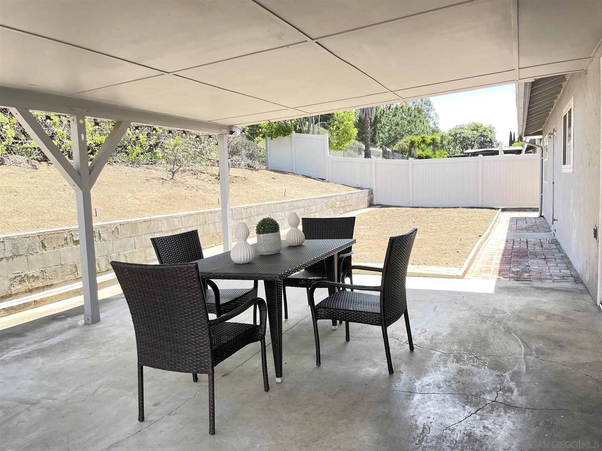 13717 Tobiasson Road Poway, CA 92064 - Photo 10 of 13 a view of a patio with table and chairs next to a yard