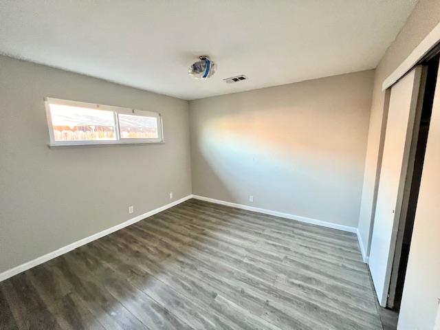 2045 Celeste Drive Modesto, CA 95355 - Photo 17 of 48 a view of an empty room with wooden floor and a window