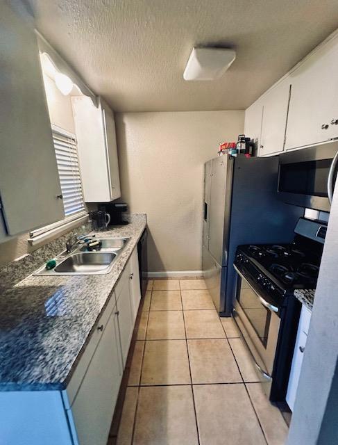 2045 Celeste Drive Modesto, CA 95355 - Photo 37 of 48 a kitchen with a sink a stove and refrigerator