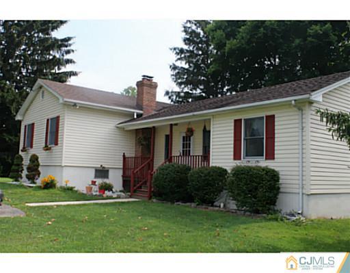 11 Butcher Road Monroe Township, NJ 08831 - Photo 1 of 18 a front view of house with a garden and plants
