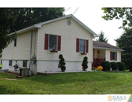 11 Butcher Road Monroe Township, NJ 08831 - Photo 2 of 18 a view of a back yard of the house