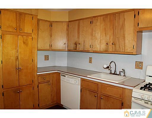 11 Butcher Road Monroe Township, NJ 08831 - Photo 14 of 18 a kitchen with a sink and cabinets