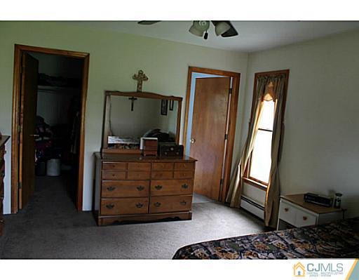 11 Butcher Road Monroe Township, NJ 08831 - Photo 15 of 18 a living room with furniture and a flat screen tv