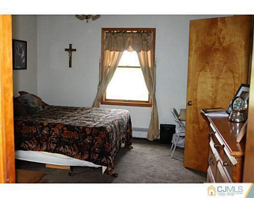 11 Butcher Road Monroe Township, NJ 08831 - Photo 16 of 18 a bedroom with a bed and a window