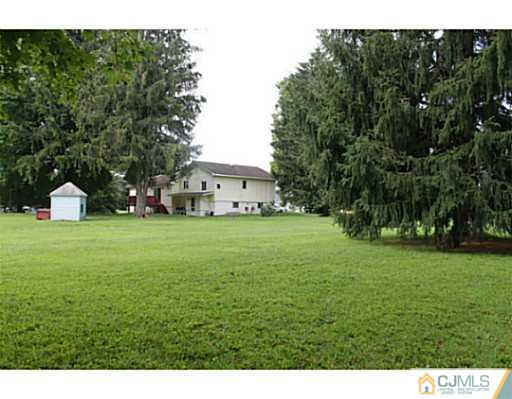11 Butcher Road Monroe Township, NJ 08831 - Photo 5 of 18 a front view of a house with garden