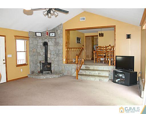 11 Butcher Road Monroe Township, NJ 08831 - Photo 9 of 18 a living room with furniture and a flat screen tv