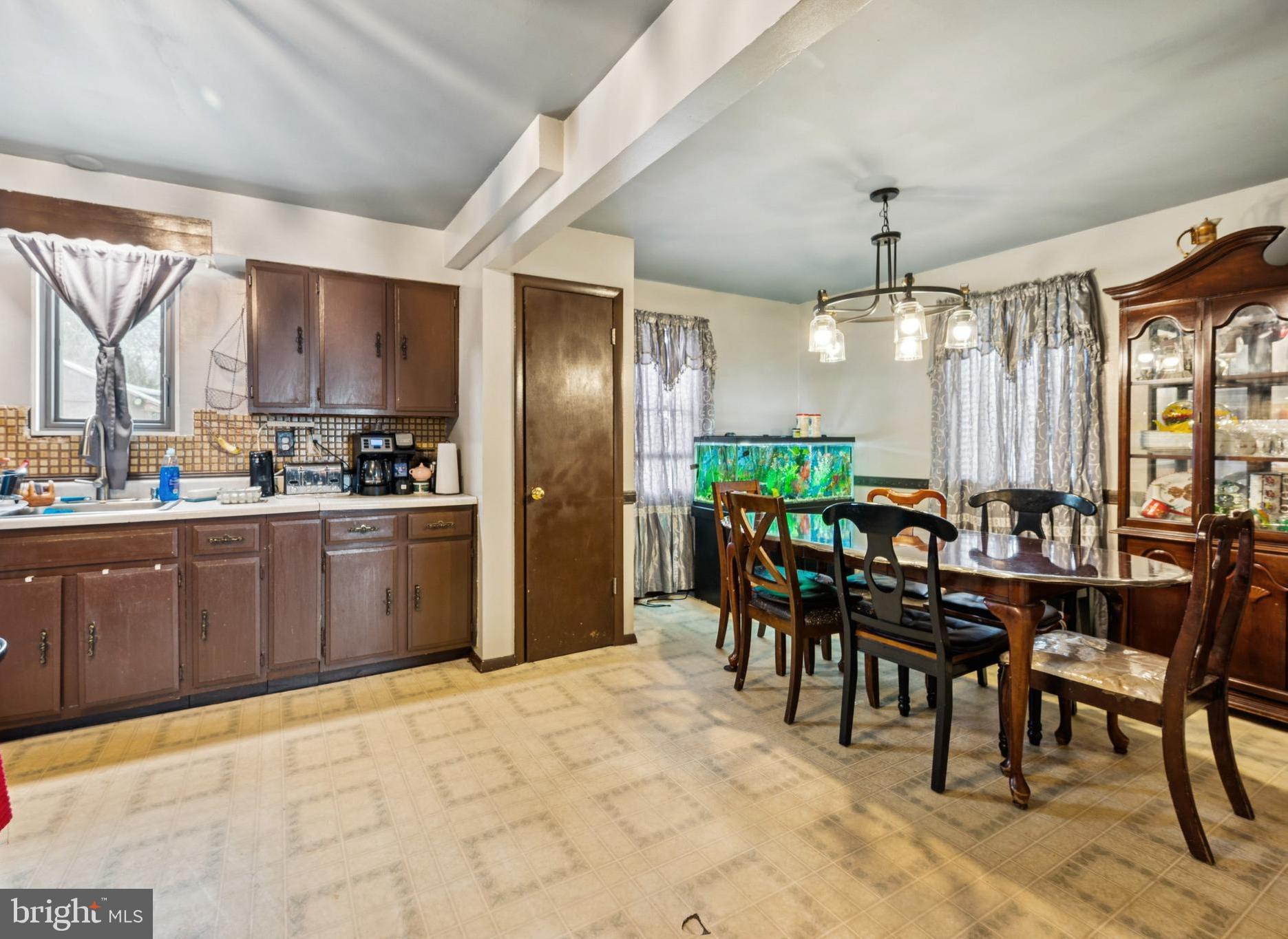 609 8th Avenue Lindenwold, NJ 08021 - Photo 11 of 25 a kitchen with stainless steel appliances kitchen island granite countertop a table chairs and a refrigerator