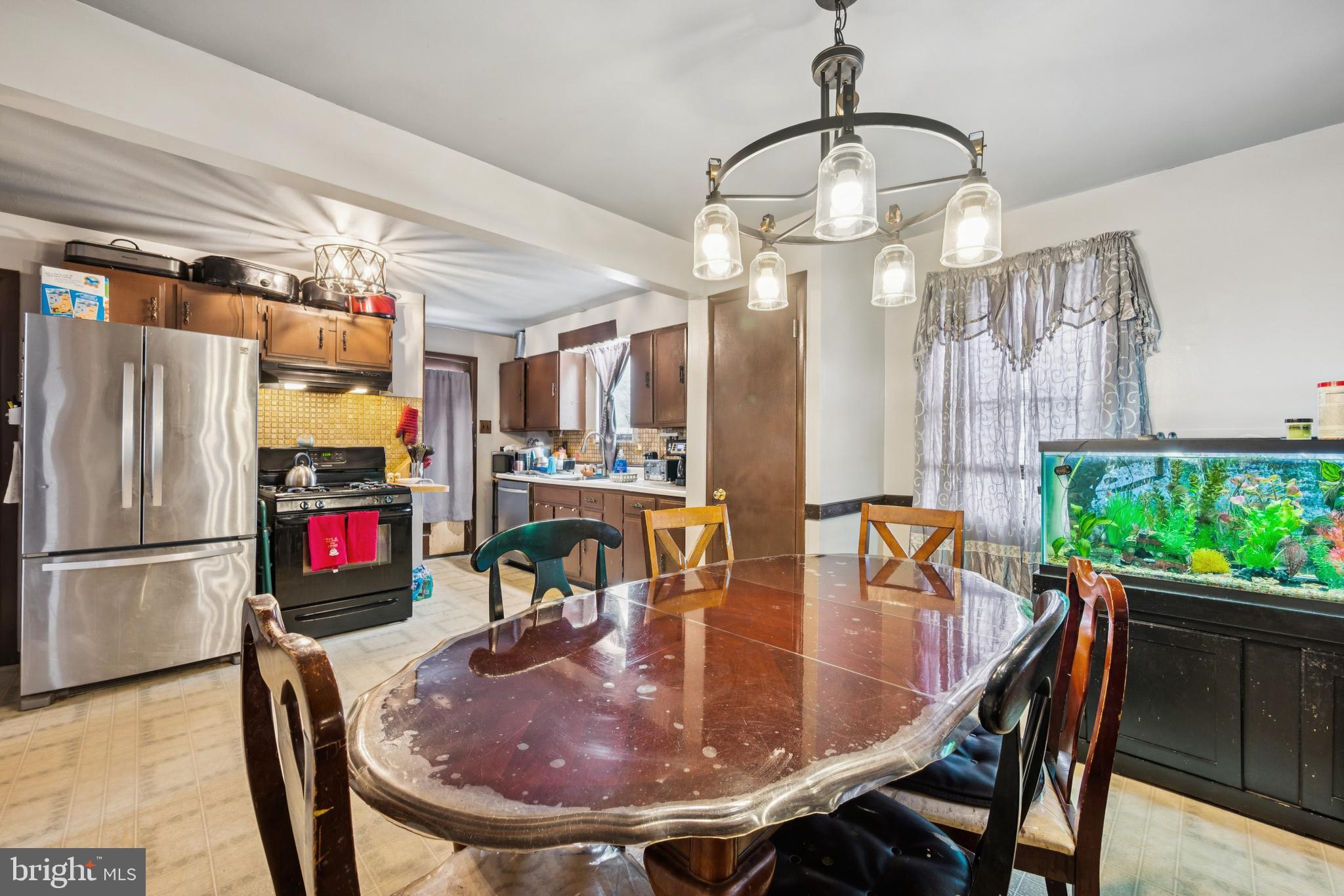 609 8th Avenue Lindenwold, NJ 08021 - Photo 15 of 25 a dining room with furniture a chandelier and wooden floor