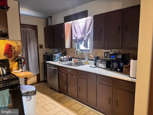 a kitchen with a sink stove and microwave