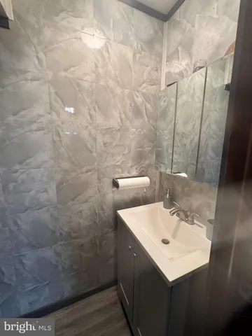 a bathroom with a sink mirror and vanity