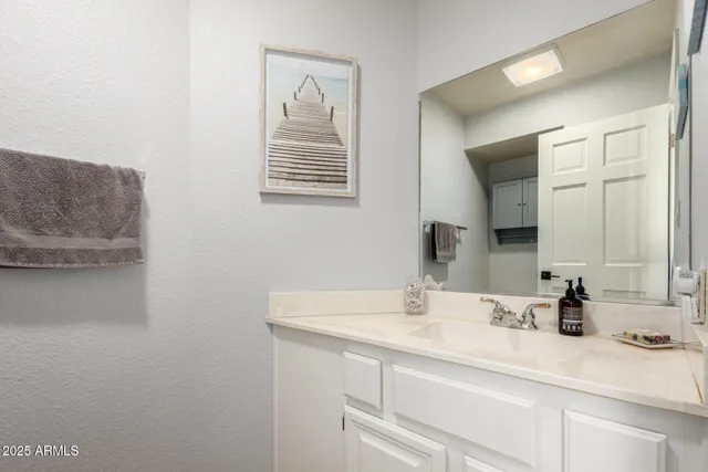 a bathroom with a sink and a mirror